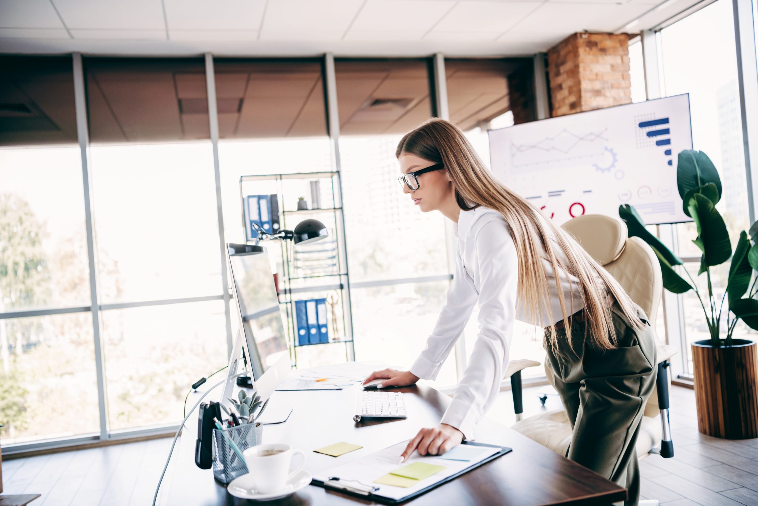 Business-woman_standing-desk_AdobeStock_1995931643
